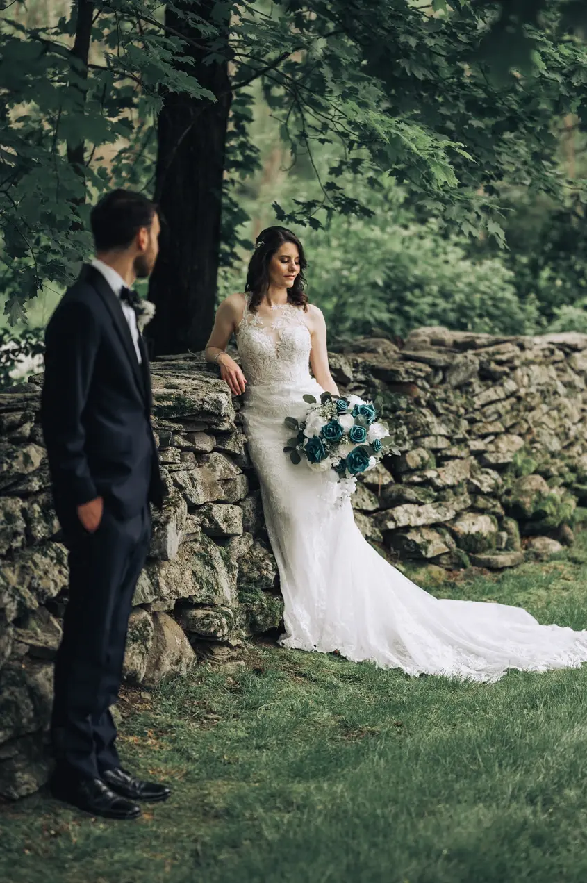 wedding couple on stone wall at mountainville manor